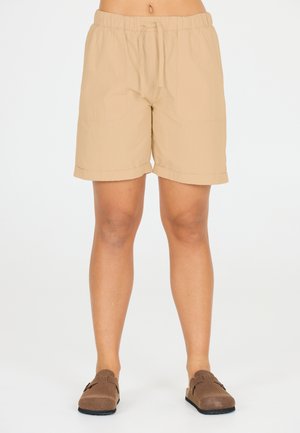 Shorts beiges en tissu léger, dotés d'une taille élastique avec cordon de serrage, de deux poches latérales et d'un ourlet replié.