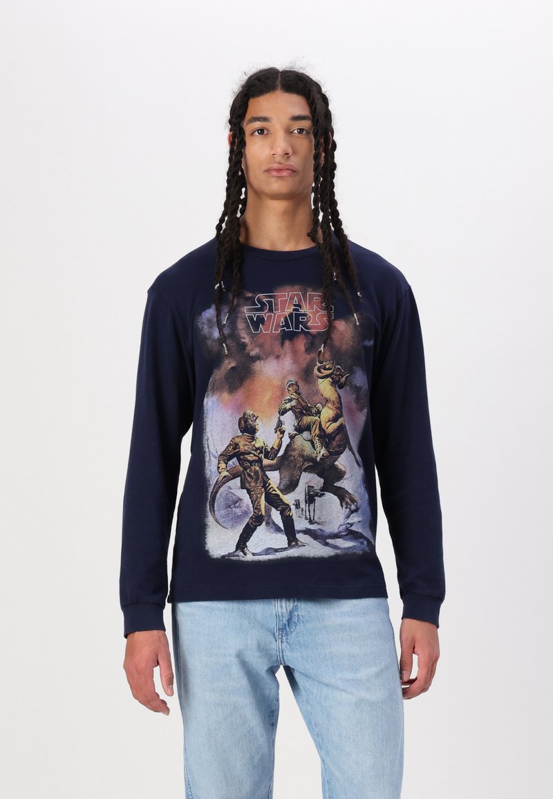 Navy long-sleeve t-shirt featuring a graphic print of characters and creatures from a sci-fi scene, with a crew neck and textured fabric.