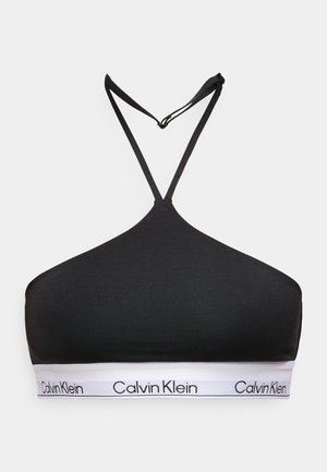 Bralette nero in morbido materiale, con forma triangolare e spalline regolabili, con fascia bianca con logo sul fondo.