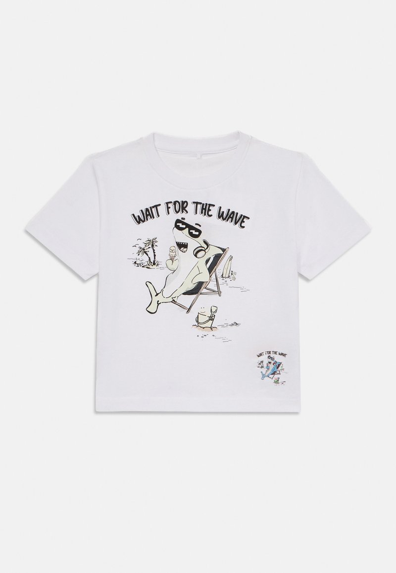 White cotton t-shirt featuring a cartoon shark print, sunglasses, and the phrase "WAIT FOR THE WAVE." Short sleeves, round neckline, relaxed fit.