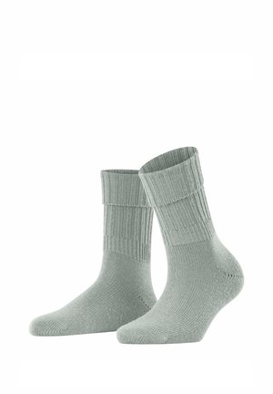 Chaussettes grises claires côtelées avec un revers et une finition douce et texturée. Conçues pour le confort et la chaleur, avec une coupe ajustée.