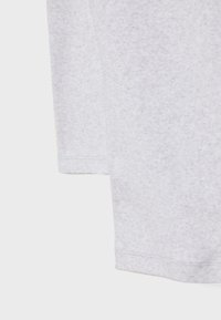 Light gray long-sleeve cotton shirt with a textured finish, featuring a straight hem and minimal stitching details.