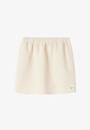Light beige mini skirt with an elastic waistband, made from soft fabric, featuring a small green brand tag on the lower right side.