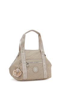 Bolso Kipling beige con correas de marca, bolsillo con cremallera en la parte frontal, logotipo circular y un pequeño llavero de mono de peluche adjunto.