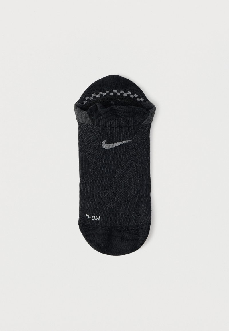 Black athletic sock made of textile with a textured surface, featuring a gray Nike logo and additional gray accent near the cuff.