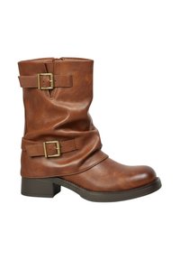 Bottines en cuir brun avec un design effondré, deux boucles sur les côtés et un petit talon carré. Présente une finition lisse et une texture subtile.
