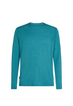 Chemise à manches longues en turquoise, fabriquée à partir d'un tissu texturé. Elle présente un col rond et une étiquette de logo discrète sur le côté inférieur.