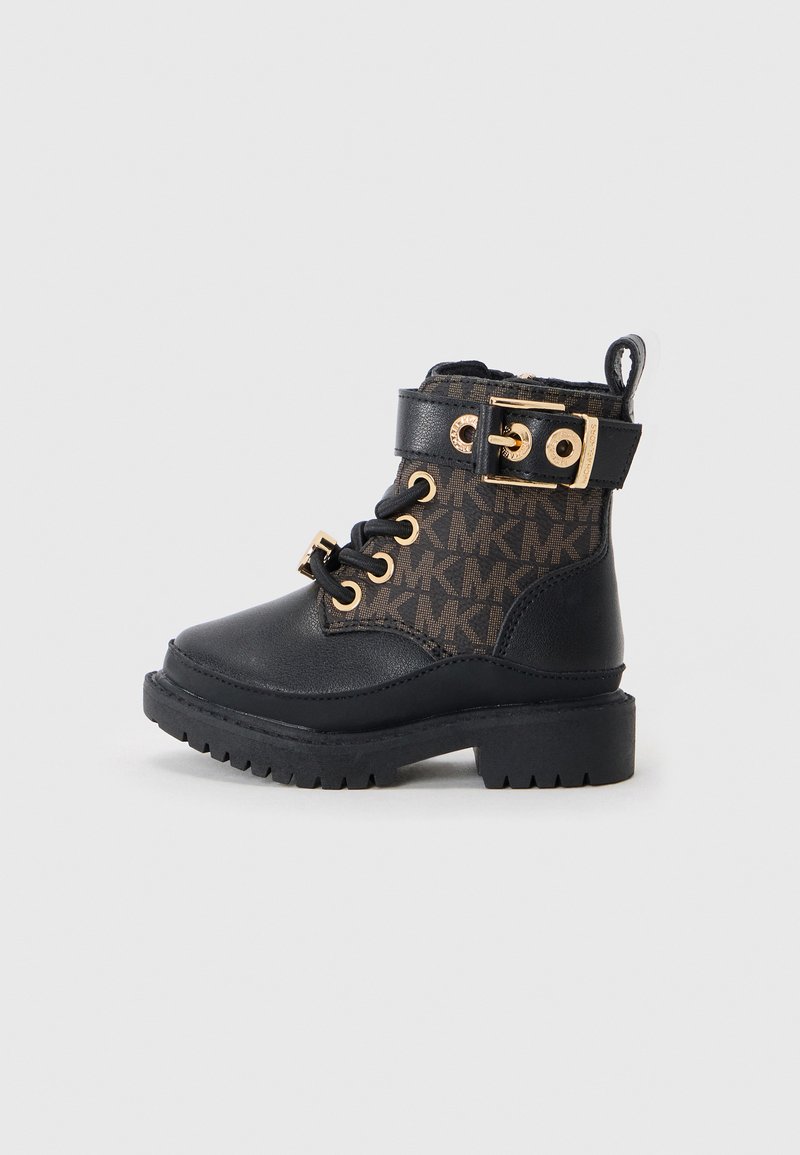 Black ankle boot with a patterned textile upper, gold hardware accents, lace-up design, and a textured rubber sole.