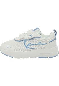 White mesh sneaker with light blue accents, dual Velcro straps, textured pattern, and a thick white sole. Features a signature on the side.
