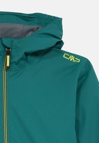Teal hooded jacket with mesh lining, front zipper with green and yellow pull tab, and yellow CMP logo on the shoulder.