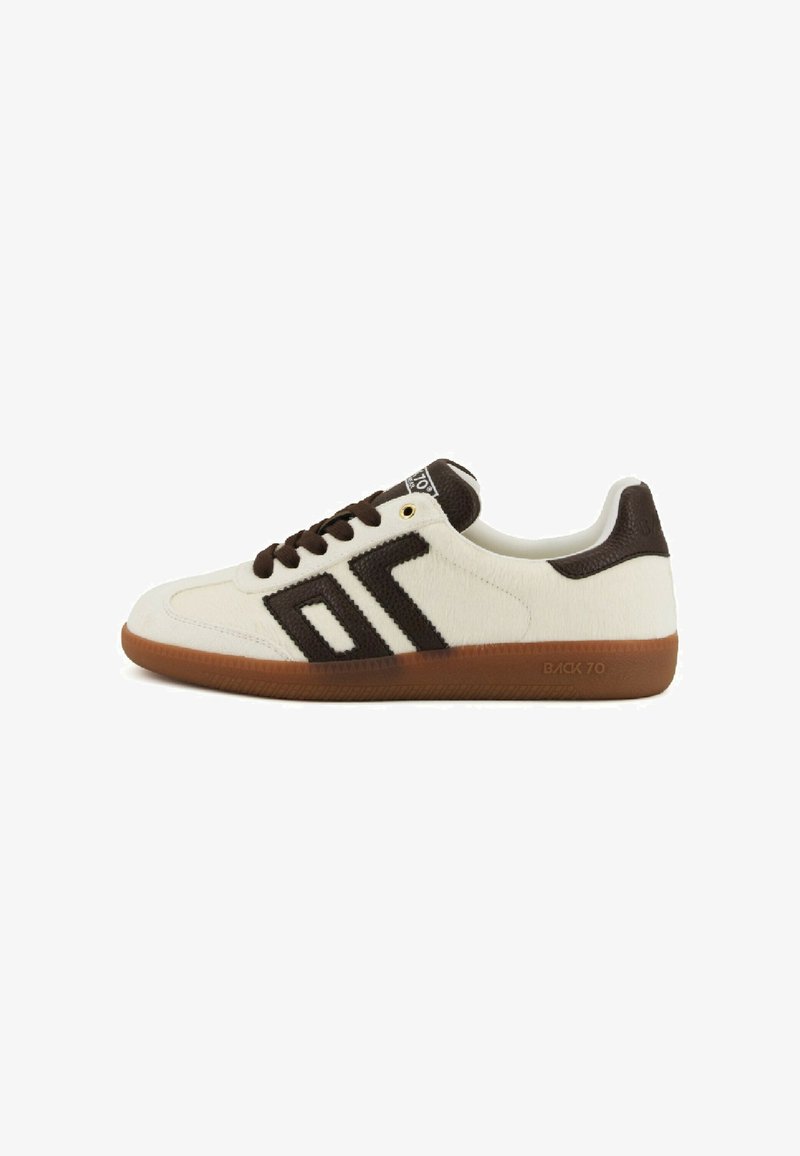 White low-top sneaker with brown laces, a brown geometric design on the side, and a gum sole labeled "BACK 70."
