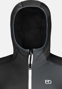 Kapuzejacke mit einer grau-schwarzen Farbgestaltung, aus dehnbarem Material gefertigt. Verfügt über einen Frontreißverschluss, weiße Akzente und ein Logo.