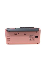 Retro-style portable record player in pink plastic with a black top, featuring ventilation grooves, button controls, and a power input.