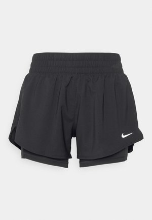 Black athletic shorts with an elastic waistband, inner lining, and side slits. Features a white Nike logo on the left front.