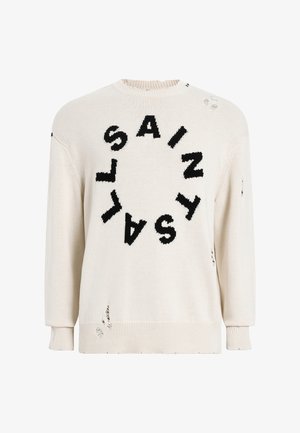 Krämfärgad stickad tröja med en rund grafik som har ordet "SAINT" i svart, med slitna detaljer samt ribbade ärmslut och fåll.