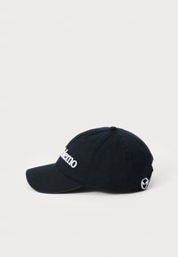 Black cotton cap with a curved brim, featuring white embroidered "Memo" text on the front and a small logo on the side.