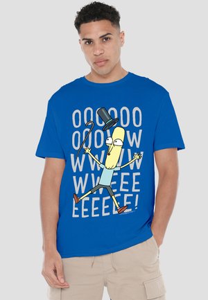 Man in blue t-shirt featuring cartoon character with top hat and cane jumping, with repeated letters and exclamation marks behind.