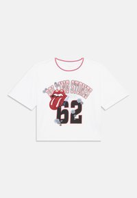 Balta īsā piedurkņu T-krekls ar īsām piedurknēm, ar sarkano un melno Rolling Stones logotipu, mirdzošu mēles grafiku un ziedu akcentiem.