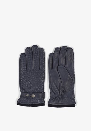Gants en cuir marine avec une texture tissée d'un côté, une finition lisse de l'autre, et une fermeture à bouton pression réglable.