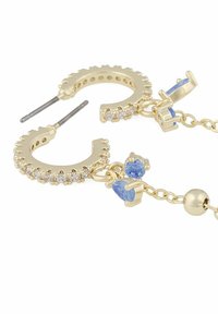 Guldörhängen har klara stenar längs den yttre kanten, med hängande blå ädelstenar fästa med delikata kedjor.