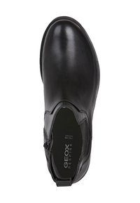 Botín de cuero negro hasta el tobillo con puntera redondeada, cremallera lateral y un sutil logotipo en la plantilla. Textura suave y diseño minimalista.