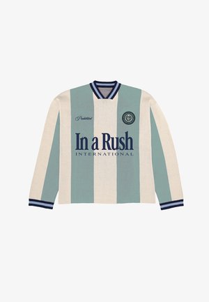 Trui met lange mouwen en ronde hals, voorzien van verticale beige en lichtblauwe strepen, marineblauwe biezen, tekst "In a Rush International" en een klein rond embleem op de borst.