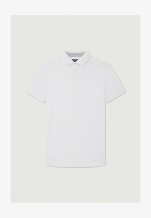 Valge polosärk, mis on valmistatud siledast puuvillakangast. Omab klassikalist krae, kolme nupuga esitab, lühikesi varrukasid ja diskreetset logodetaili.