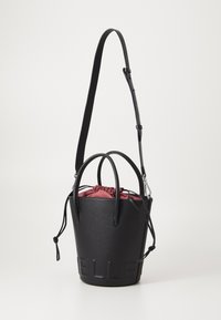 Black textured leather bucket bag with dual handles and adjustable strap. Features red drawstring accent and embossed logo on front.