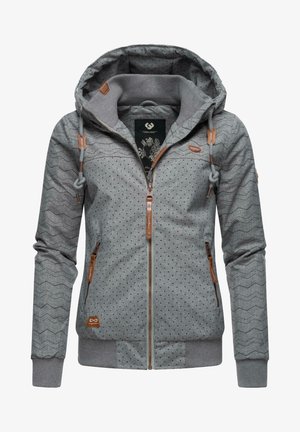 Chaqueta gris con capucha y cremallera, con pequeños puntos negros, mangas en forma de chevron, bolsillos frontales y tiradores de cremallera de cuero marrón y detalles.