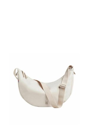 Beige shoulder bag with a curved shape, zipper closure, adjustable strap, and logo detail. Made from durable, smooth material.
