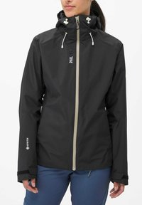 Black waterproof jacket with a hood, featuring a light zipper, adjustable drawstrings, and a slim fit. Includes GORE-TEX logo on sleeve.