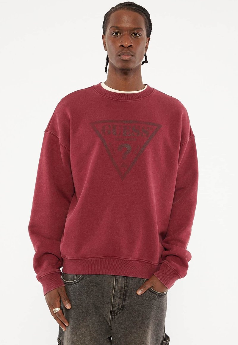 Bordeaux sweatshirt met een ronde hals, voorzien van een zwart driehoekig logoontwerp in het midden. Zacht, textuurstof met geribde manchetten.