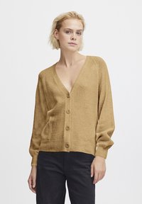 Beige, gestrickte Strickjacke mit V-Ausschnitt, sieben Knöpfen auf der Vorderseite, gerippten Bündchen und Saum. Lange Ärmel und lockere Passform.