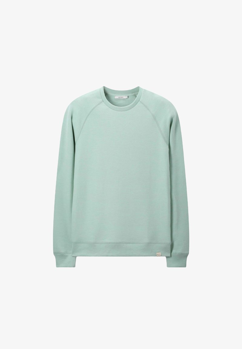 Sweatshirt vert menthe avec un col rond, des manches raglan et des poignets côtelés. Fabriqué en matière douce, présentant une petite étiquette à l'ourlet.