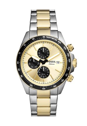 Montre chronographe avec un cadran or et noir, un bracelet en acier inoxydable et ton or, une échelle tachymétrique et trois sous-dials pour le double fuseau horaire.