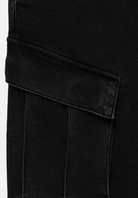 Tissu en denim noir présentant un revers plié et cousu. La texture est lisse avec une légère brillance, affichant des lignes nettes et droites.