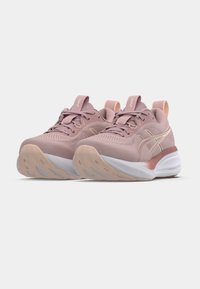 Pink athletic shoes with a textured mesh upper, lace closure, and a cushioned sole featuring a white midsole and light brown traction outsole.