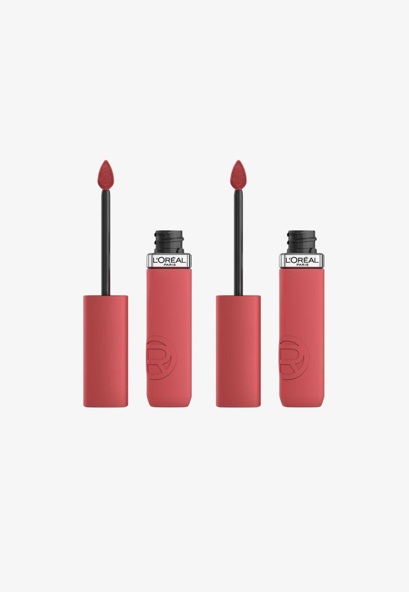 Rouge à lèvres liquide dans un tube à finition mate. L'applicateur a une pointe effilée pour une application précise. Il présente un design élégant et arrondi.