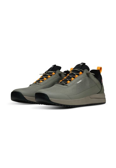 Grey athletic shoes with black accents, mesh upper, orange laces, and textured sole with grooves for traction.