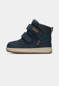 Baskets montantes bleu marine avec deux bandes Velcro, en matériau en suède texturé, semelle en caoutchouc beige et un petit logo sur le côté.