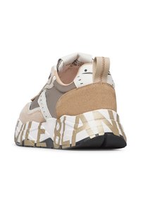 Sneaker spessa beige e grigia con tacco in suede, suola bianca con grande lettering color nocciola e un tassello di presa sul retro.
