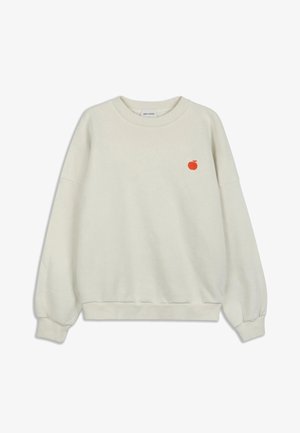 Kreemi värvi särk, mis on valmistatud pehmest kangast, koos väikese punase tikitud õunaga rinna piirkonnas ning ribakujuliste mansettide ja äärega.