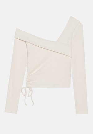 Top de manga larga y sin hombros en tela de canalé color marfil, con un lazo lateral fruncido y un diseño de escote asimétrico.