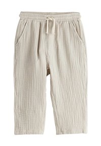 Světlé béžové texturované kalhoty s elastickým pasem, zavazováním na šňůrku a bočními kapsami. Celý model má žebrovaný vzor.