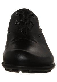 Black leather shoe with a rounded toe, lace-up design, and small hardware accents. The sole features textured traction for grip.