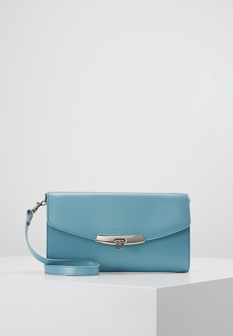 Blå läder crossbody-väska med en silverfärgad spänne, platt design och avtagbar rem. Har präglad logotyp och slät yta.