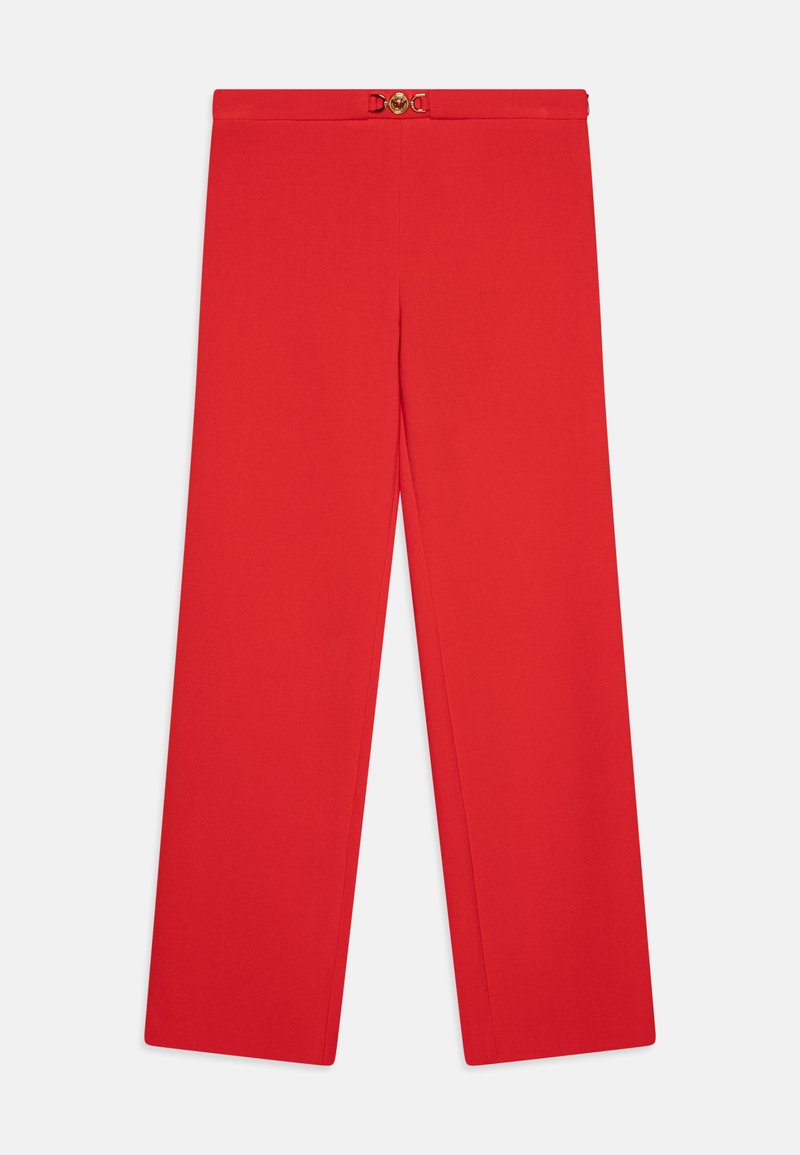 Red wide-leg trousers made of smooth fabric, featuring a belt with a gold circular buckle at the waist and front pleats.
