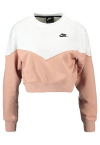Vit och rosa kortärmad sweatshirt med ett chevrondesign, med rund hals, långa ärmar och en liten svart Nike-logotyp på bröstet.