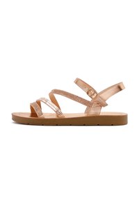 Rose gold strappy sandals with a flat sole, featuring textured straps and a buckle. Smooth finish and cushioned insole for comfort.
