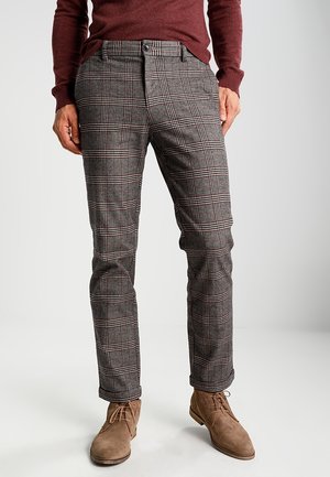 Gray plaid trousers with a checked pattern, featuring red and black accents. Made from textured fabric, styled with a tailored fit.